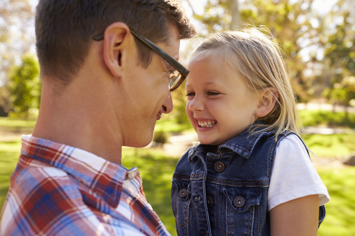 Dad reassuring daughter and laughing